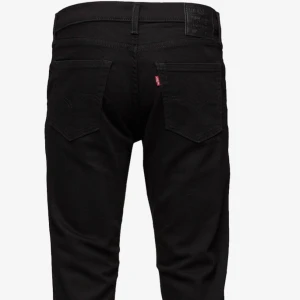 Svarta Levi's 511 jeans W31 L32 - Färgen är lite borta på jeansen asså dem är inte så svarta. Skriv om man vill se fler nära bilder.Säljer ett par svarta Levi's 511 jeans i klassisk femficksmodell. Jeansen har en slim passform, raka ben och är tillverkade i mjukt denimtyg. Snygga detaljer med svarta sömmar och Levi's ikoniska läderpatch baktill. Perfekta för en clean och stilren look.