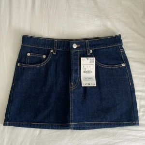 Mörkblå jeanskjol - Säljer en mörkblå, lågmidjad jeanskjol🩵 (Tryck ej på köp nu!!) Aldrig använd med lappen kvar. Storlek är S / 36, längd 34 cm och midjemått 38 cm. Sitter lågmidjat på mig som har 39/40 cm i midjemått. 