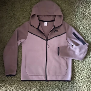 Nike tech fleece  - Säljer en beige och brun nike tech fleece. Storleken är M men kan även passa som M beroende hur man vill att passformen ska vara (L mer tight M mer loose). Säljer för den har suttit i garderoben i ett tag och inte används.