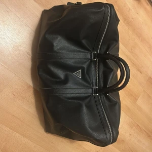 Guess weekendväska - En snygg väska från Guess. Den är gjord av läder och den passar perfekt till resor. Vid frågor är det bara att höra av sig!