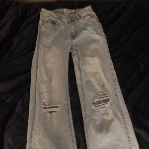 Ljusa jeans med slitningar från Boulevard Star - Snygga ljusa jeans från Boulevard Star med coola slitningar på knäna. Perfekta för en avslappnad stil. De har en klassisk femficksdesign och knappgylf.