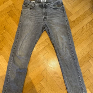 Grå jeans från Jack & Jones  - Säljer ett par jeans från Jack n Jones i modellen Chris. Byxorna har en rak passform. Storlek W30xL32. Använda men i bra skick, skulle säga 7/10. Pris går att diskutera vid snabb affär💰. Vid fler frågor eller funderingar hör av dig!