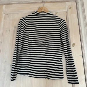 Svartvit randig tröja från Lindex - Säljer en stilren svartvit randig tröja från Lindex. Tröjan är superstretchig och passar perfekt till både vardag och mer uppklädda tillfällen. 