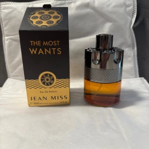 Azzare The MOST WANTED  - Parfymen The Most Wants från Jean Miss kommer i en snygg svart och guld kartong. Flaskan är rund med en cool metallisk silverfärgad topp och ett bärnstensfärgat glas. Eau de Parfum, 100 ml. Perfekt för dig som gillar stilrena och moderna dofter.