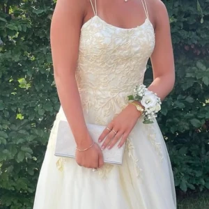 Ljusgul långklänning med spets - Intressekoll på studentklänning. Hör av er om ni är sugen på att köpa. Den är använd två gånger till bal, super fin ljusgul klänning. Går att justera i storlek med hjälp av snörena i ryggen. Hör av dig om du vill ha fler bilder också😊