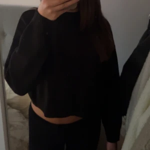 Svart croppad tröja - Säljer en svart croppad tröja med långa ärmar.