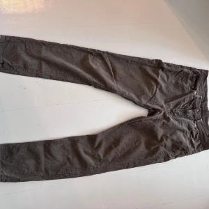 Bruna manchesterbyxor Paul & friends - Säljer ett par bruna manchesterbyxor från Paul & friends i storlek 33. Byxorna har klassisk femficksdesign, dragkedja och är tillverkade i mjuk bomull. Perfekta för dig som gillar en avslappnad men ändå stilren look.