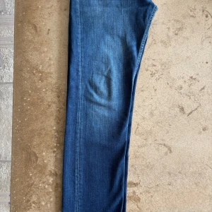 Replay Grover straight jeans blå - Säljer ett par klassiska Replay Grover jeans i blå denim. Modellen är straight fit med normal passform och standard midja. Jeansen har fem fickor och snygga kontrastsömmar. Perfekta för dig som gillar en tidlös look med bekväm känsla.