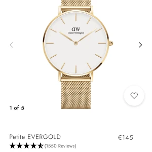Guldig Daniel Wellington klocka - Stilren klocka från Daniel Wellington med vit urtavla och armband i guld. Köpt för 1400 kr.