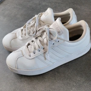 Vita sneakers från Adidas - Säljer ett par klassiska helvita sneakers från Adidas. Silvrig logga. Skinn.