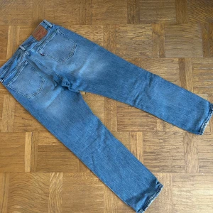 Levis 541 - Klassiska Levis 541 jeans i en snygg blå tvätt. De har en rak passform likadant som 501or och är tillverkade i slitstarkt denim. Perfekta för en avslappnad stil. Jeansens ikoniska läderpatch och femficksdesign ger en tidlös look.