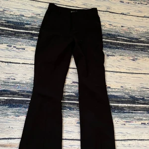Kostymbyxor från Gina Tricot - Kostymbyxor från Gina Tricot i storlek: 32. Lågmidjade och loose bootcut. Pris är diskuterbart och hör av dig om det är något!