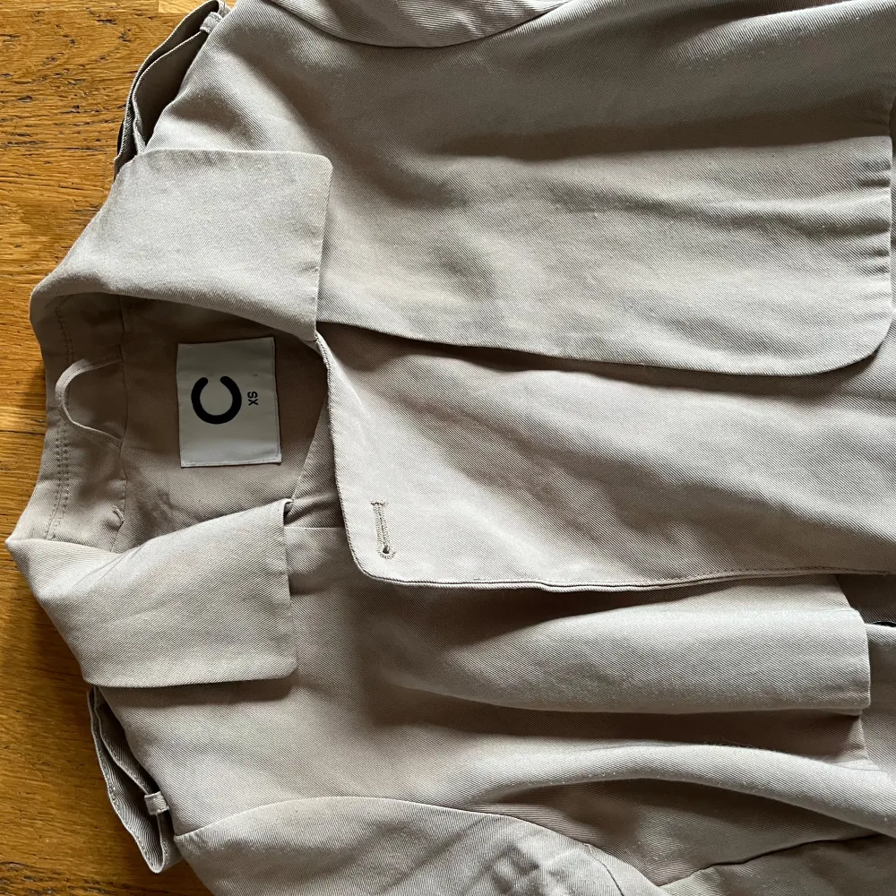 Snygg beige trenchcoat i storlek xs Jackan har ett klassiskt snitt med knytbälte i midjan och lite mer åt de tunnare hållet. Perfekt för vår och höst.💕. Takit.