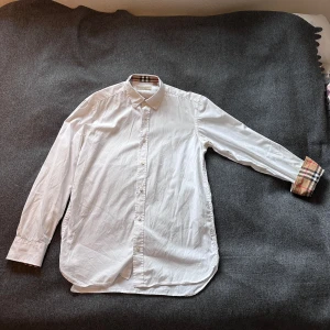 Vit skjorta från Burberry  - Säljer en burberyy skjorta i storlek S/M passar S bäst. Fått i julklapp för länge sedan och inte använt speciellt mycket samt så har den blivit för liten och därav säljer jag den. Skriv gärna vid intresse eller frågor!
