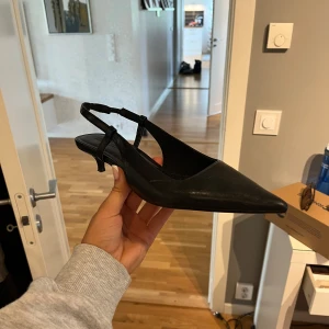 Svarta klackskor - Säljer ett par svarta klackskor från Pull&Bear med smal klack och öppen häl. Använda en gång men inga defekter alls, säljer då de är lite för stora för mig som har 37 egentligen!