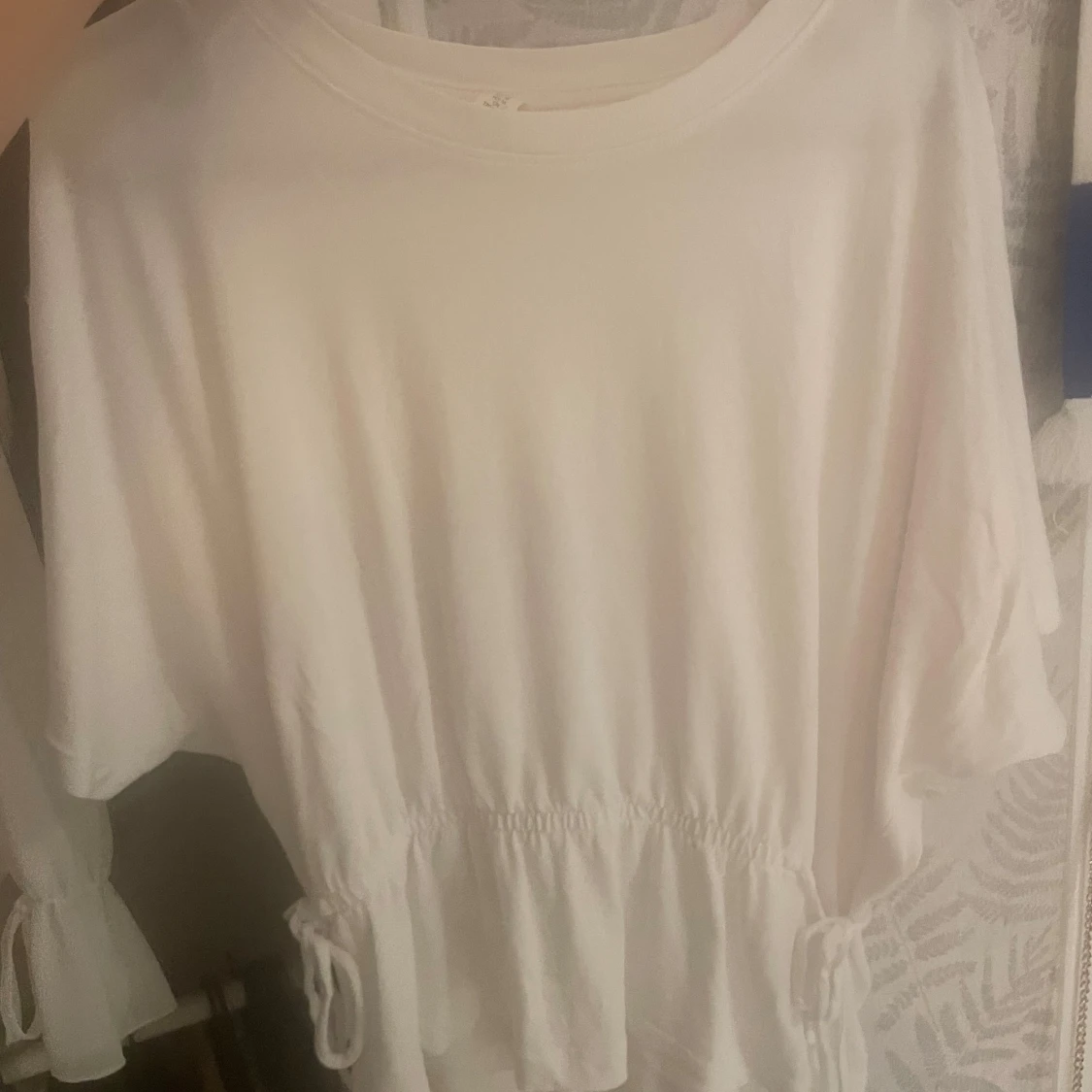 Vit tröja med snörning i midjan