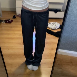 Mörkgråa mjukisbyxor Ladies Lounge S - Mörkgråa mjukisbyxor från Ladies Lounge i storlek S. Byxorna har rak passform, resår i midjan och snörning framtill. Dom är väldigt tunna och sköna 