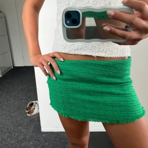 Grön kortkjol med fransig kant - Cool grön kjol med shorts bak