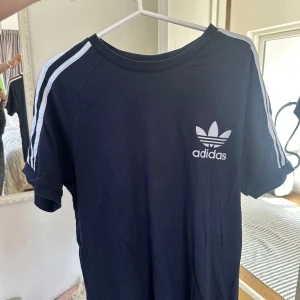Y2K streetwear vintage adidas t-skjorta mörkblå & vit - AHS, Pinterest stil adidas skjorta. Bra med bootcut jeans och hoops örhängen t.ex. (hur jag skulle stajla den). Lös och skön och inga fläckar eller tecken på missbruk.