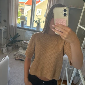 Beige stickad tröja från Zara - Säljer en beige stickad tröja från Zara med korta ärmar och rund hals. Tröjan har en ribbad struktur och är gjord i ett mjukt material som passar perfekt för höst och vår. Enkel och stilren design som är lätt att matcha med andra plagg. Storlek 140💓