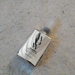 Color Wow Dream Coat Supernatural Spray - Color Wow Dream Coat Supernatural Spray i en snygg silverfärgad plastflaska med spraymunstycke. Innehåller 50 ml och är perfekt för att ge håret en glansig, frizzfri finish. Flaskan är kompakt och lätt att ta med i väskan.