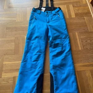 Skidbyxor  - Blåa överdragsbyxor i storlek 146-152