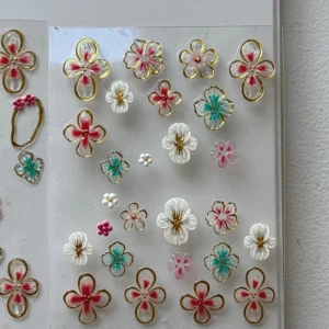 Blommiga nagelklistermärken - Söta blommiga nagelklistermärken i olika färger som rosa, vit och turkos med gulddetaljer. Perfekta för att ge dina naglar en unik och färgglad look. 100/sheet