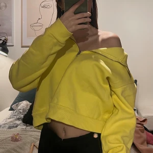Gul croppad hoodie - Säljer en snygg gul croppad hoodie med dragkedja från bikbok