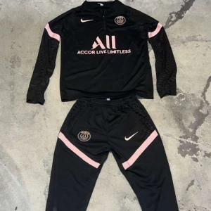 Psg Set  - Säljer en svart långärmad PSG set från Nike med rosa detaljer och klubbmärke, Har bara använt den runt 4 gånger. Pris kan diskuteras