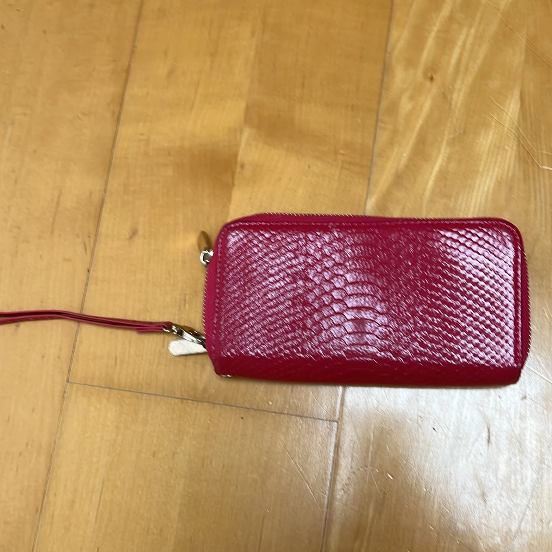 Röd plånbok med ormskinnsmönster