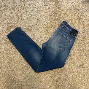 Blå Replay Anbass hyperflex slim jeans - Säljer ett par mörkblå Replay Anbass jeans med en slim passform och en skön wash. Mycket bra skick, endast en liten anmärkning vid ena fickan, närbild skickas på begäran. storlek 30/32, passar nog även w31, mått kan såklart skickas vid osäkerhet. Postas antigen samma dag som köp eller dagen därpå🙌💯