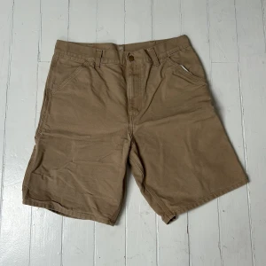 Beige Carhartt work shorts - Säljer nu mina cargo shorts från Carhartt. De är i bra skick och perfekta nu i sommaren!🙌(shortsen är baggy)