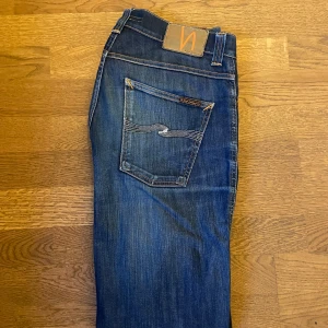  Jeans från Nudie  - Säljer ett par snygga blå jeans från Nudie Jeans. Bra skick 8/10 och använt fåtal gånger. Säljer eftersom de är lite för små för mig, bara höra av er vid funderingar! Sydda i skrevet men det varken syns eller liknande!
