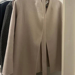 Beige kappa från WERA - Elegant beige kappa från WERA med en stilren design. Köptes ny nu i vintras men har tyvärr inte kommit till användning. Nypris 2500 mitt pris 1200kr 🤍