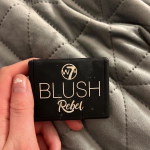 Blush Rebel från W7 - Säljer en Blush Rebel från W7 i en snygg kompakt förpackning med inbyggd spegel. Färgen är en varm, jordnära ton som ger en naturlig glöd till kinderna. Perfekt för att fräscha upp looken!