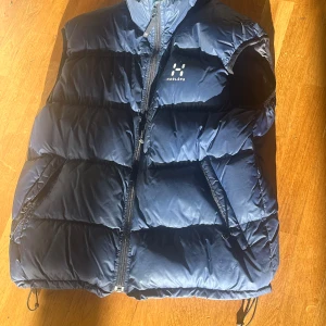 Haglöfs dunväst - Mörkblå Dunväst från Haglöfs i storlek L. Sparsamt använd.