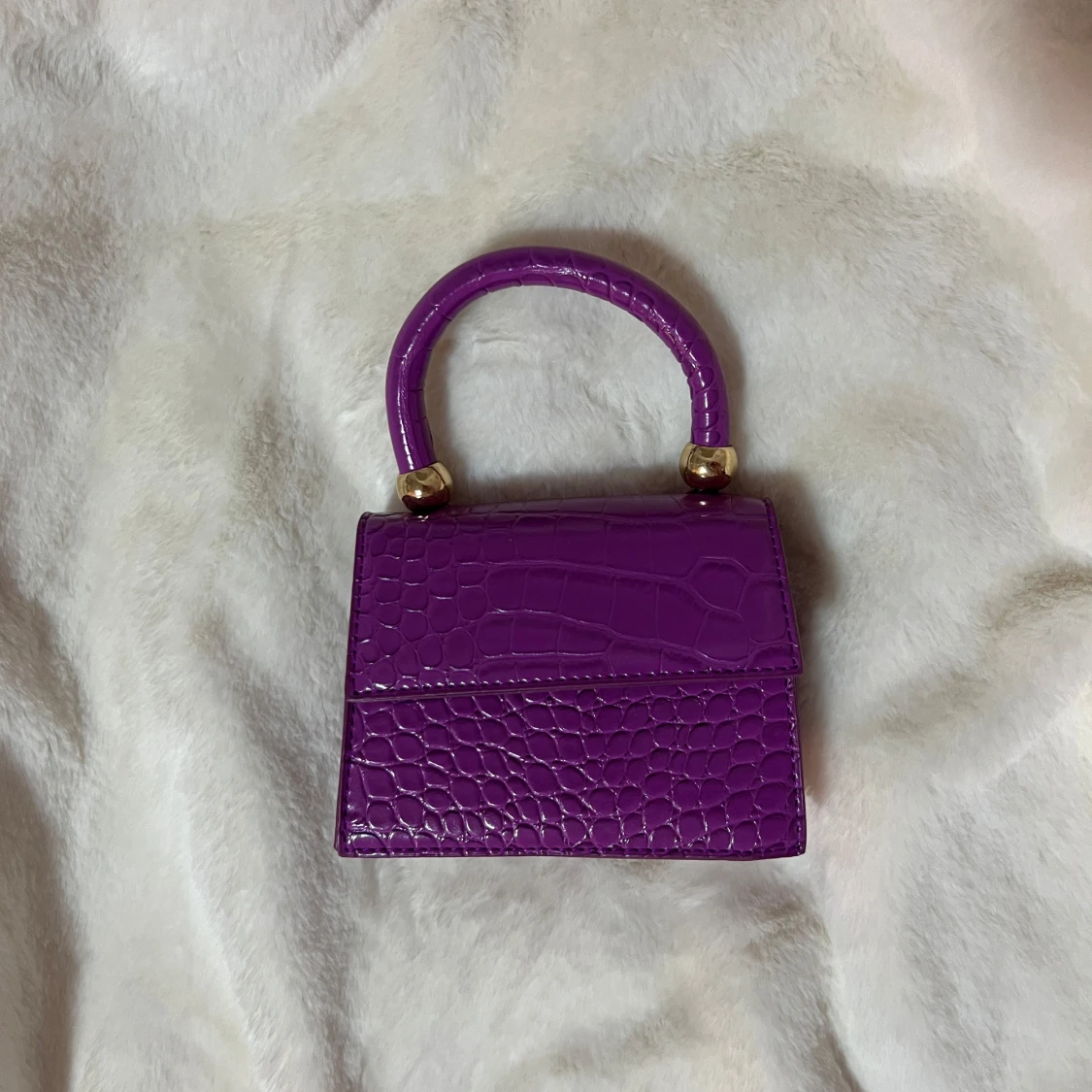Lila axelväska med krokodilmönster