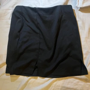 Svart miniskirt - Kort svart minikjol med liten slit. Bra skick från HM. Jag brukar ha XS och den sitter bra på mig! 🤩
