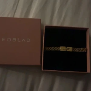 Guldarmband från Edblad - Snyggt guldarmband från Edblad med en elegant design. Armbandet har en stilren kedja och ett dekorativt lås som ger en modern touch. Armbandet är i nyskick och köptes för 499, pris kan diskuteras 💕