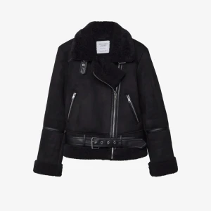 Svart jacka från Zara - Snygg svart jacka från Zara med dragkedja och bälte. Jackan har en mjuk, teddy-liknande insida och långa ärmar med läderdetaljer. Perfekt för kyligare dagar. Nypris 800kr