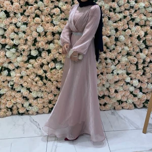 Esma Blush Pink Shimmering Belted Gown - This gown boasts romance and elegance in it's shimmering material and curve-accentuating fit. It has puff shoulders, covered neckline and sequined belt. The gown is fully lined. Size XS 34-36. 100% polyester Made in 🇹🇷Worn once. Original price 1800