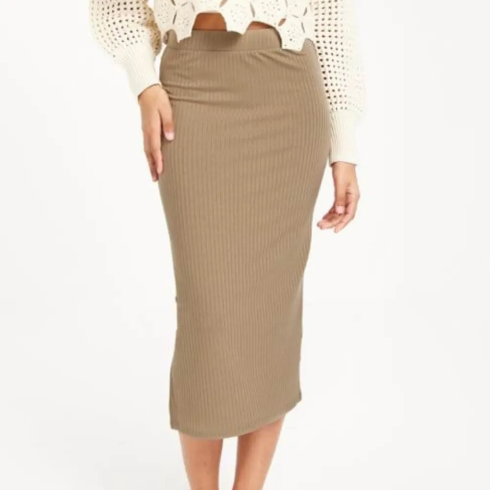 Beige/brun kjol med slitsdetalj på sidan, från ASOS i strl M. Använd vid ett tillfälle och är i mycket fint skick.. Kjolar.