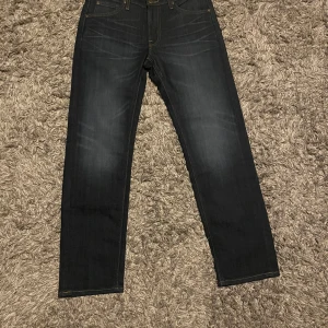 Mörkblå jeans från Lee - Jag säljer ett par helt NYA jeans från Lee pga att dom inte passar och jag fick inte byta de. Inget fel på byxorna dom är helt oanvända alltså 10/10 skick. Dom kostade 1100 nya. 