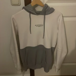 Vit och grå hoodie från McKenzie - Säljer en snygg och bekväm hoodie från McKenzie i storlek S. Den har blivit för liten för mig därför säljer jag den.