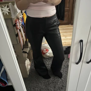 Svarta skinnbyxor - Snygga svarta skinnbyxor med låg midja och bootcut. Från Bershka!