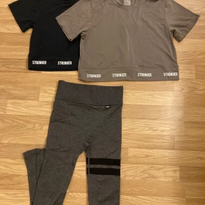 Tights och croppad topp från Stronger - Säljer en svart och en grön croppad topp, samt grå tights från Stronger. Osäker på om dottern ens använt, så mkt fint skick. 