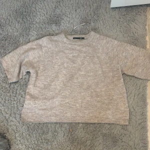 Beige stickad tröja från 157 - Säljer en mysig beige stickad tröja från 157. Den har ett litet hål men de syns inte så mycket