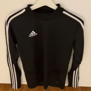 Svart långärmad tröja från Adidas - Säljer en svart långärmad tröja från Adidas i serien climacool. Adidas-loggan är tryckt på bröstet. Fin tröja som kan användas både till vardags och träning 🌺