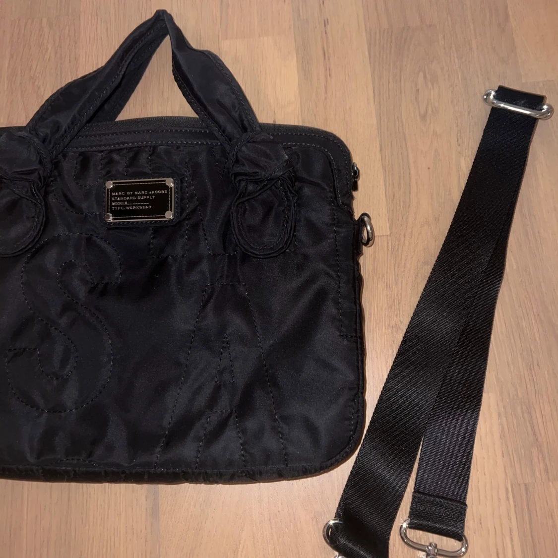 Svart datorväska med quiltad design