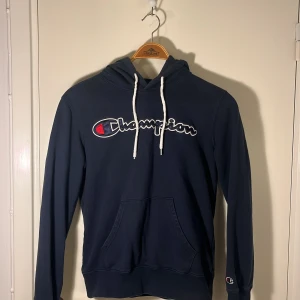 Champion Hoodie - Mörkblå Hoodie som använts ett par gånger men som fortfarande är i bra skick. Inga skador alls. Storlek S.   Kom DM för eventuella frågor